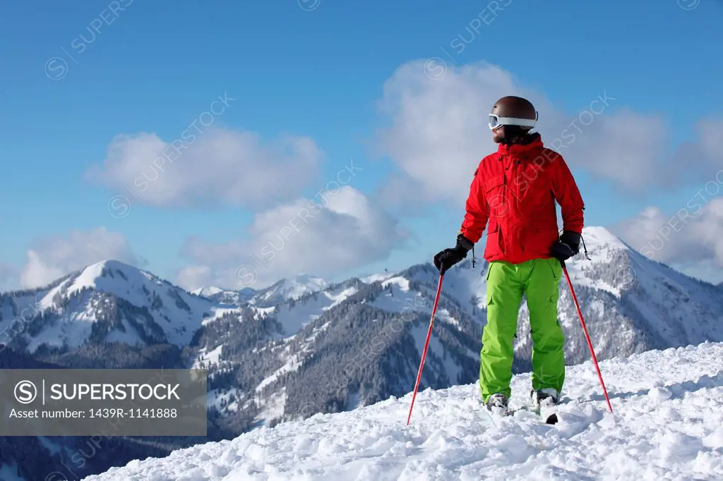 Skier taking in mountain scenery