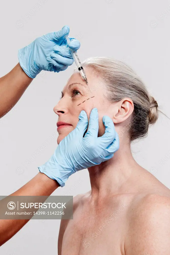 Mature woman receiving injections