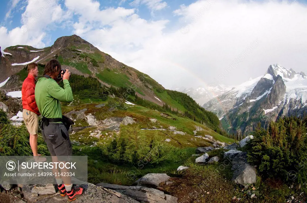 Photographing rainbow in mountains, White Rock Lakes, Ptarmigan Traverse, North Cascades, Washington, USA