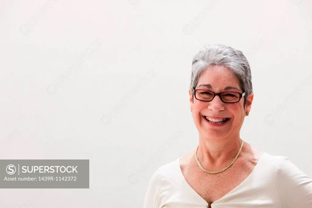 Portrait of mature woman smiling, studio shot