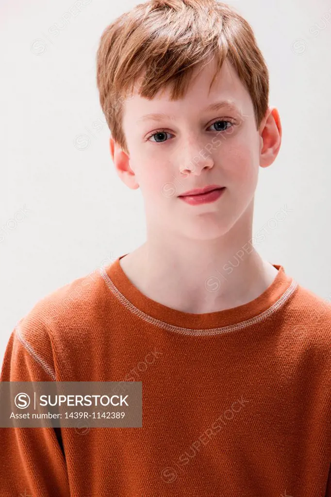 Portrait of boy in brown sweater, studio shot