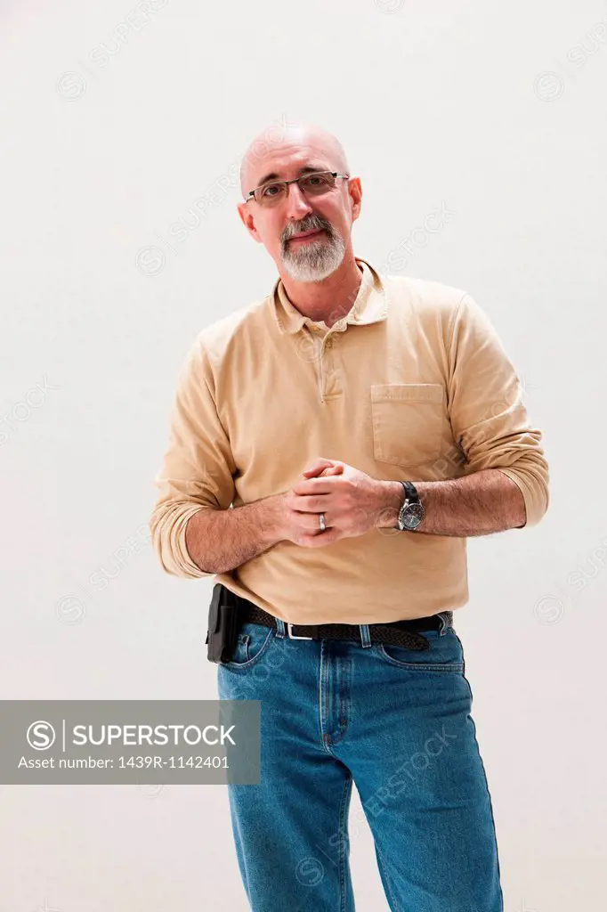 Mature man with hands clasped, studio shot