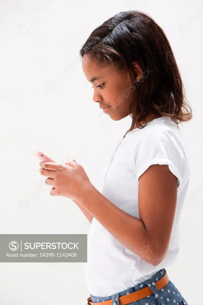 African American girl using cellphone, studio shot