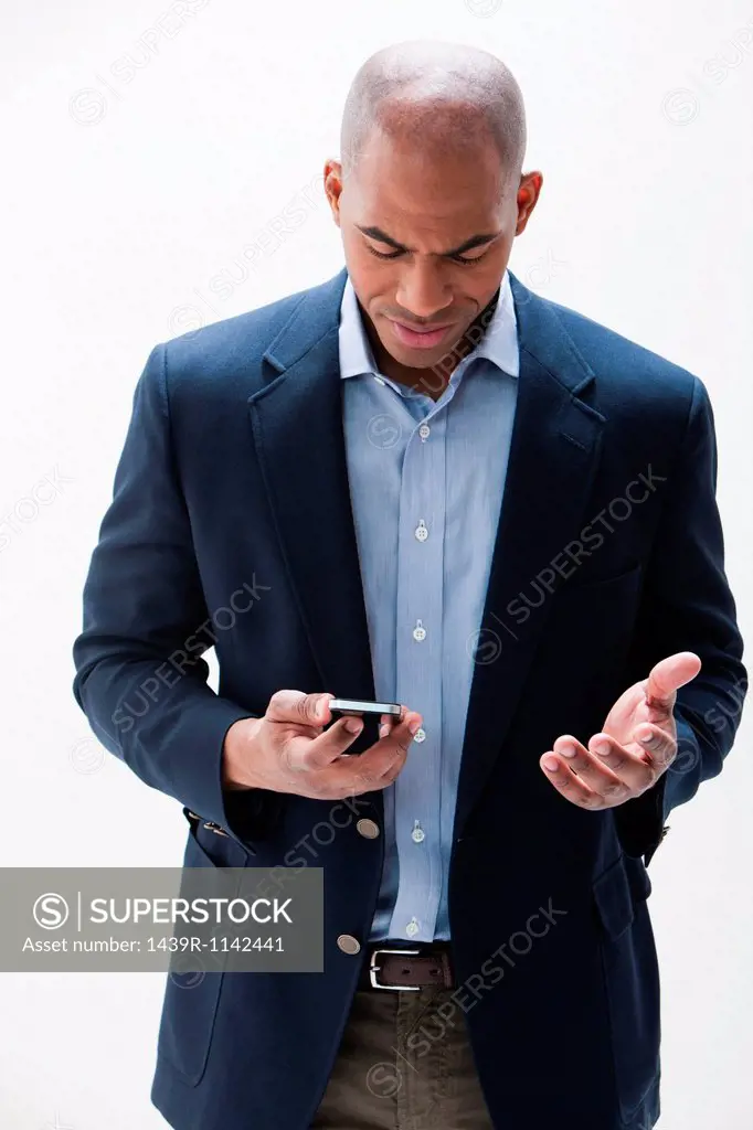 African American man using cellphone, studio shot