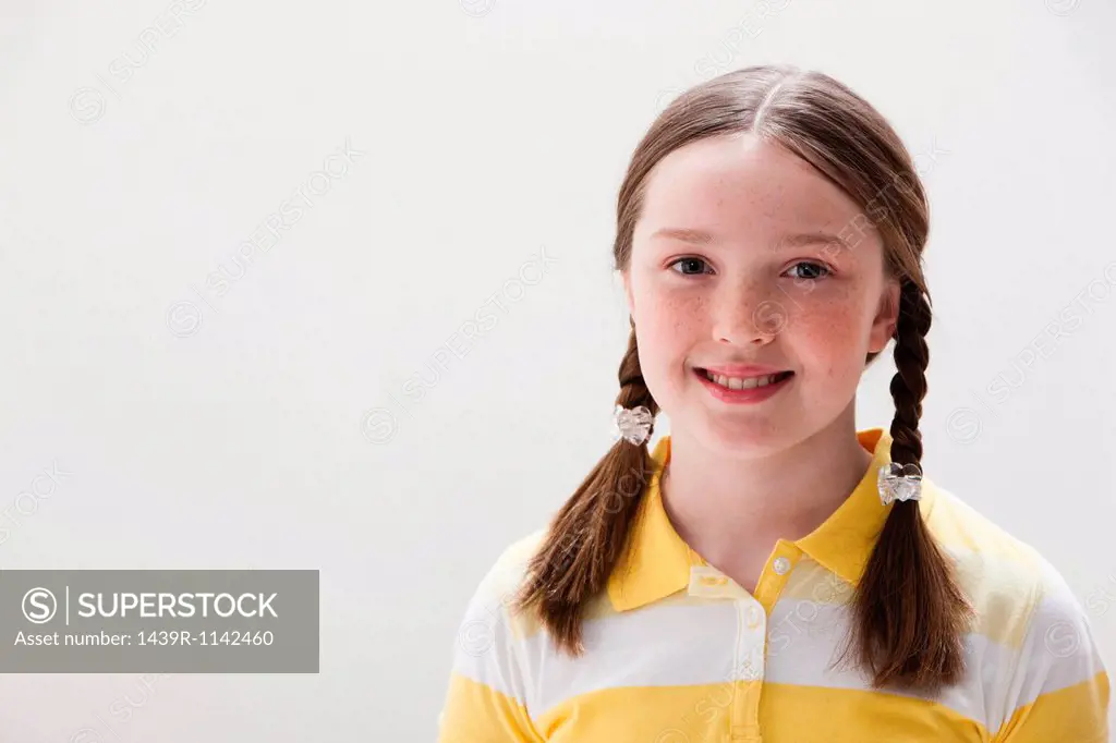 Portrait of girl smiling, studio shot