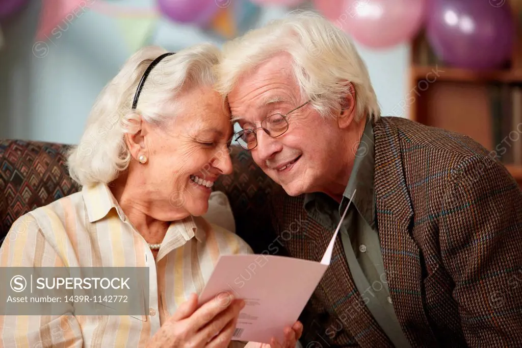 Senior couple reading birthday card