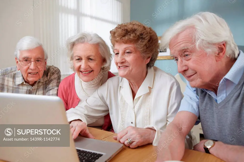 Senior adults using laptop