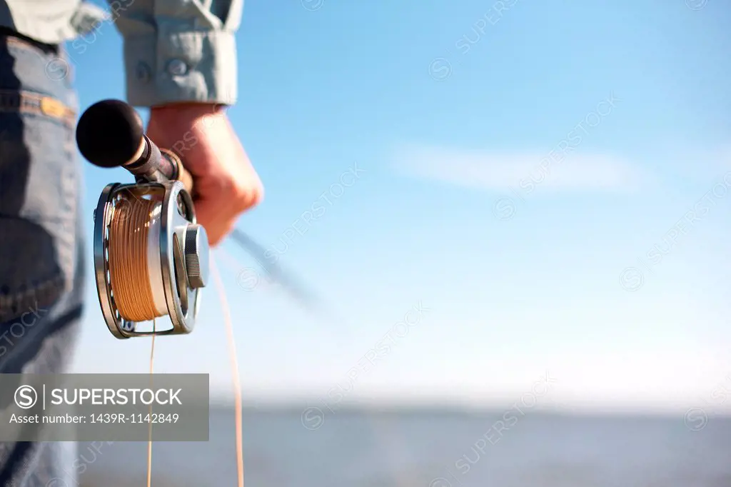 Fisherman holding a fly rod