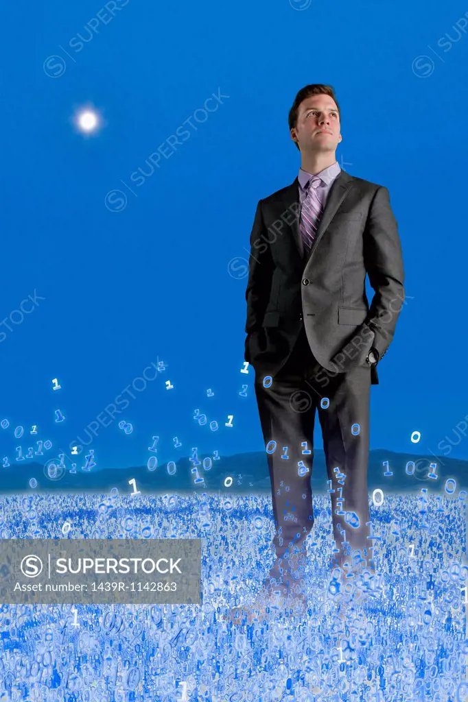 Businessman standing in binary field