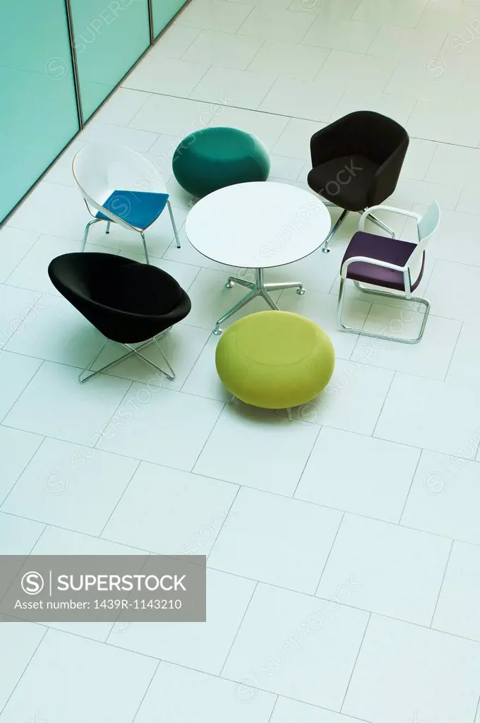 Chairs and table in empty office block, high angle view
