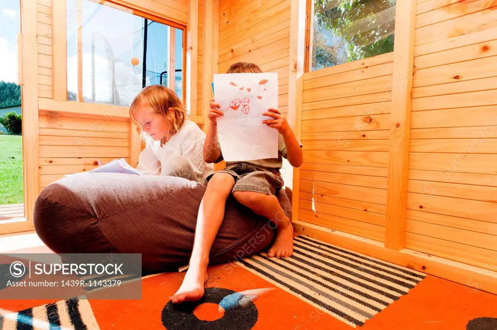 Children in a wooden playhouse