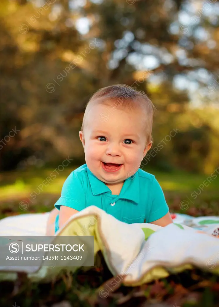Baby boy on blanket in the park