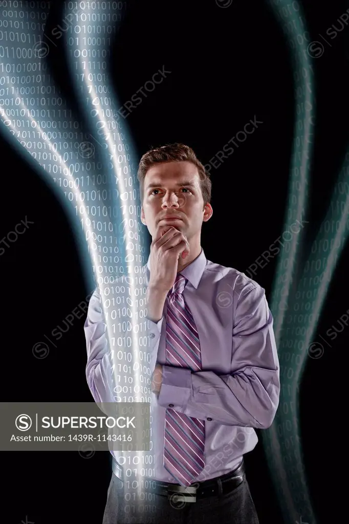 Businessman looking at data streams