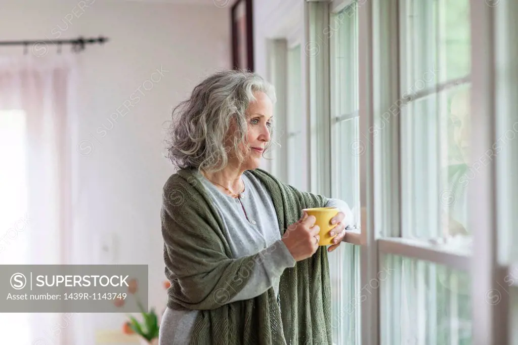 Senior woman looking out of window