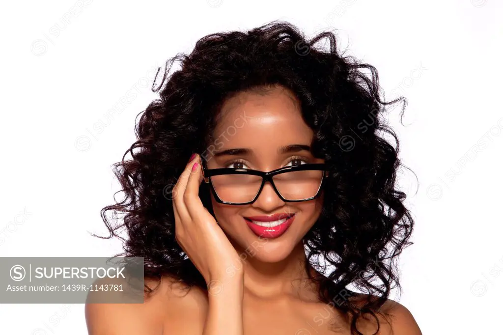 Young women wearing spectacles against white background