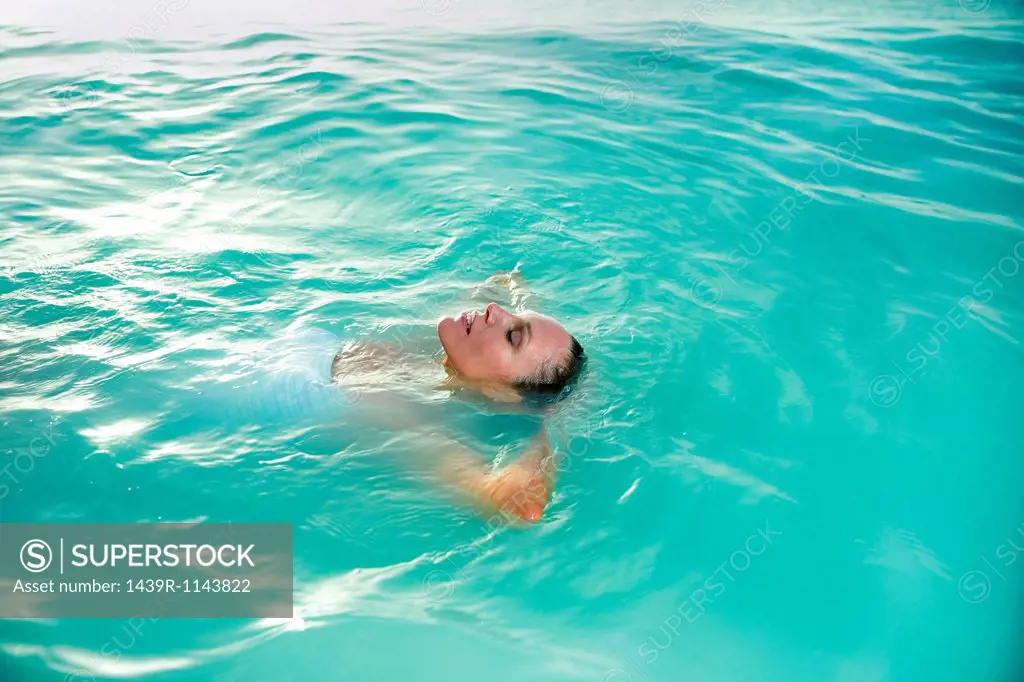 Relaxed woman floating in ocean