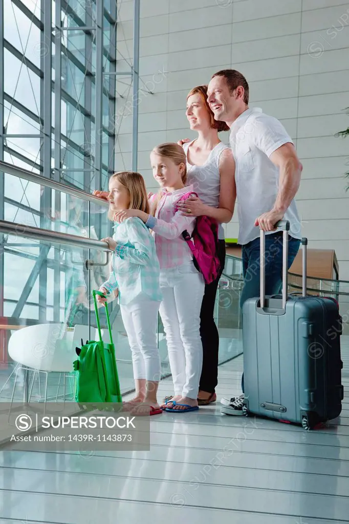 Family in airport with luggage