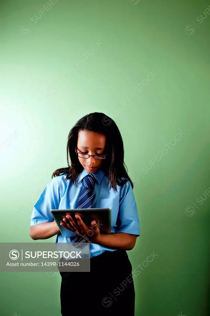 Schoolgirl using digital tablet