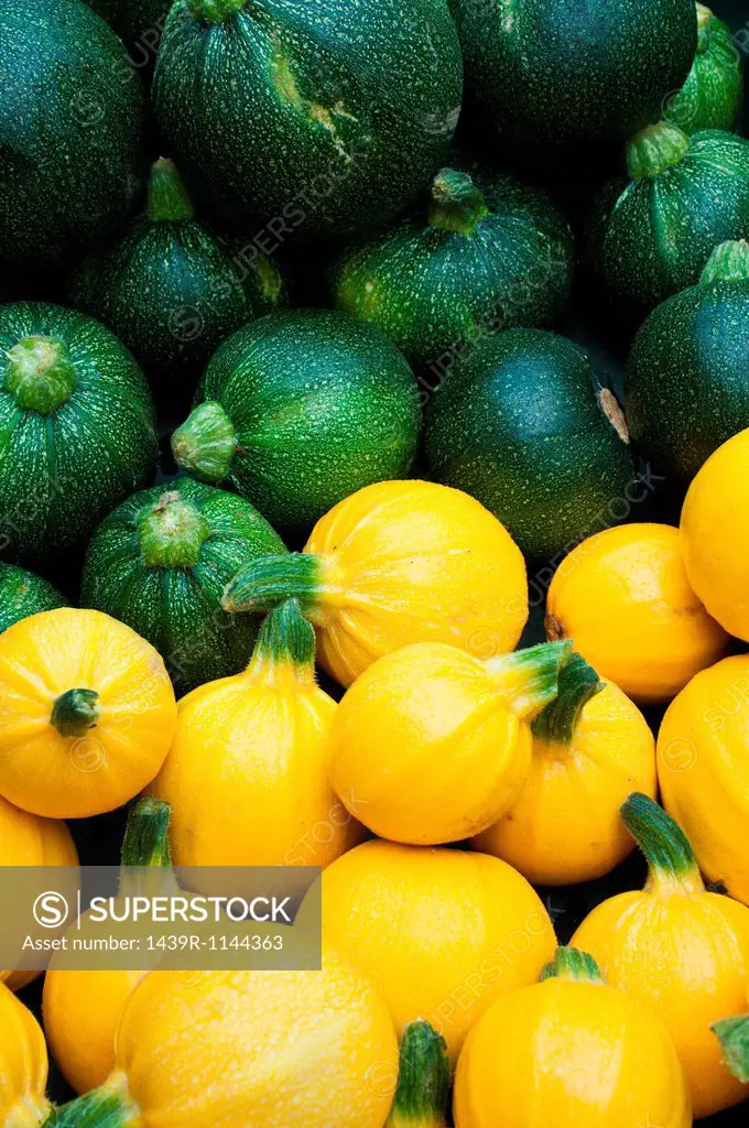 Round yellow and green courgettes