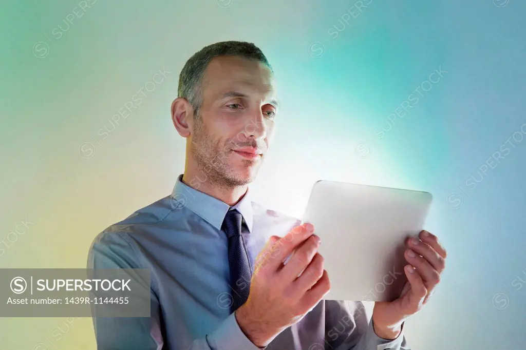 Businessman using digital tablet with lights