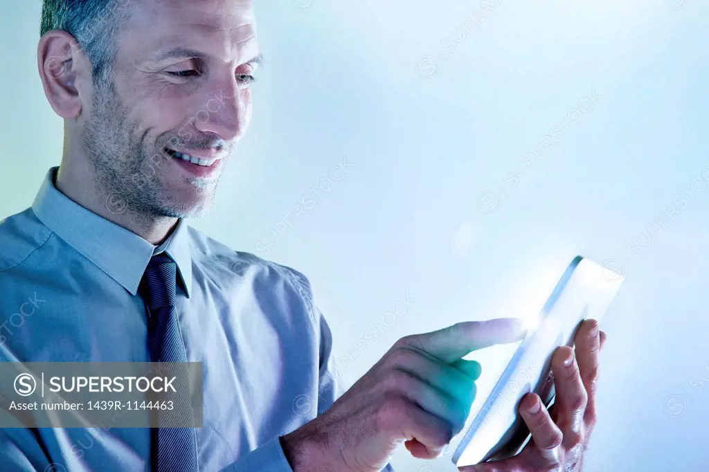 Businessman using digital tablet with lights