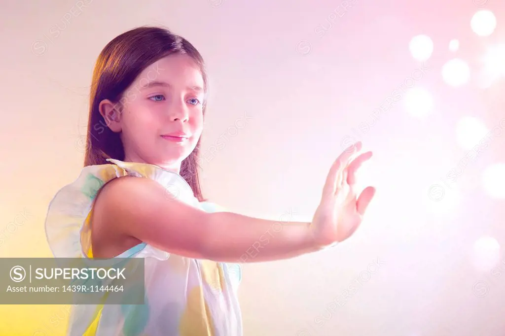 Girl reaching out to lights