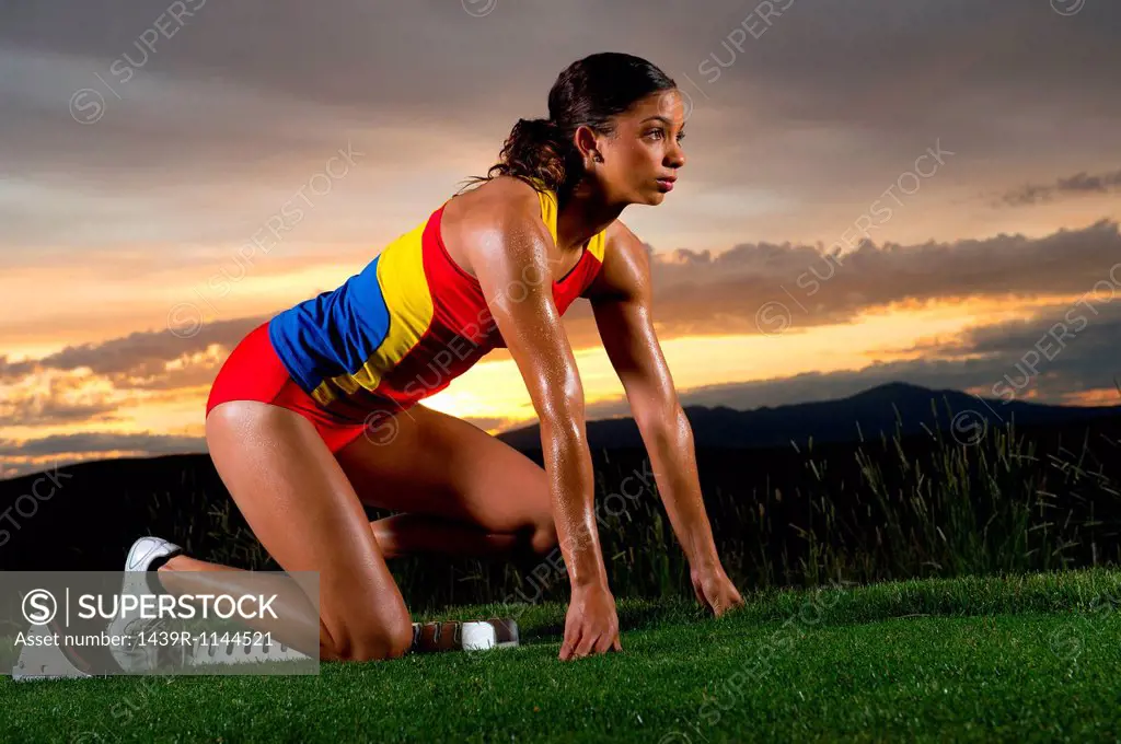 Female athlete on starting blocks