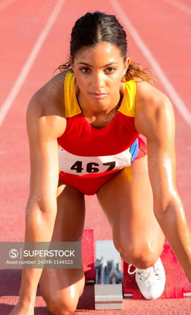 Female athlete on starting blocks