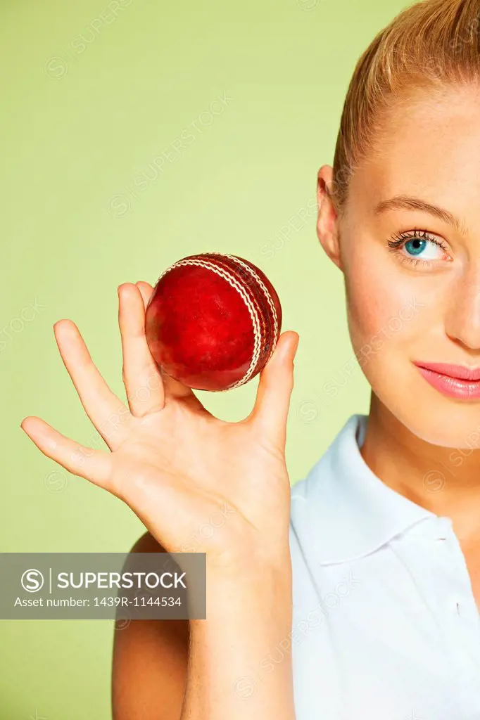 Young woman holding cricket ball