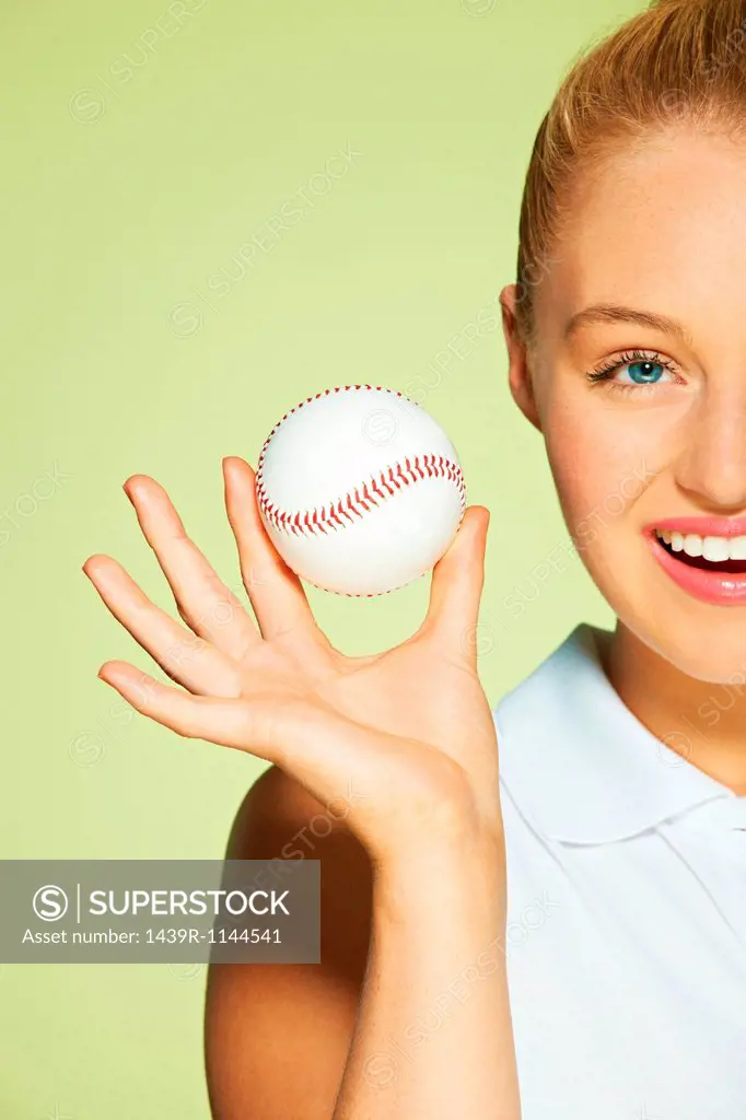 Young woman holding baseball