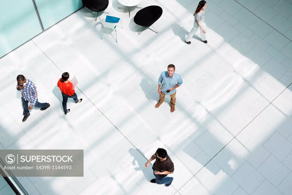 Man standing on office concourse