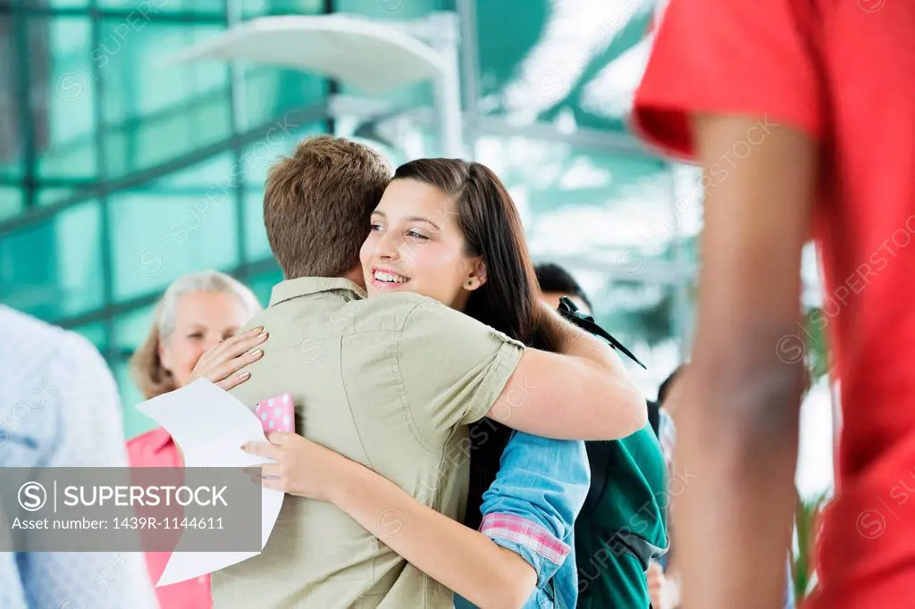 Young couple hugging in airport