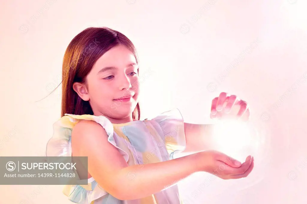 Girl holding a ball of light