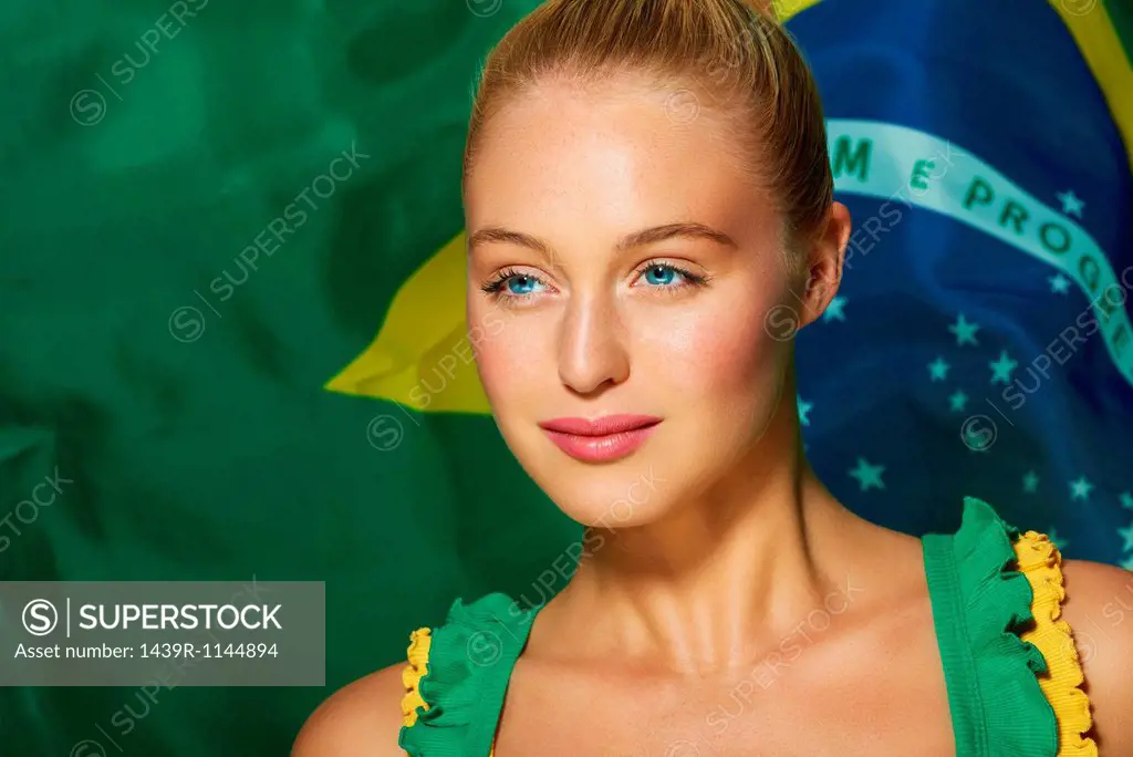 Young woman in front of Brazilian flag