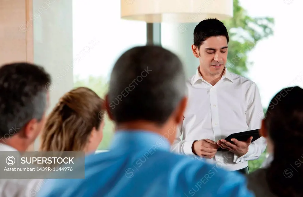 Man using digital tablet in business meeting