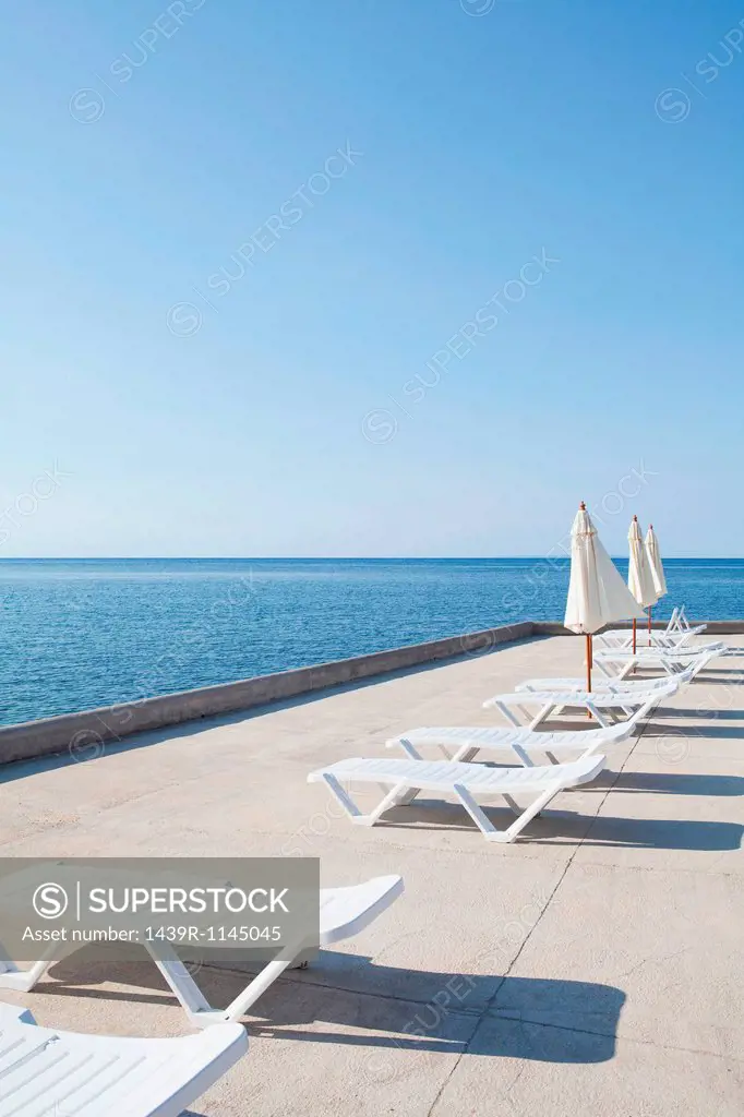 Sun loungers on deck by the ocean