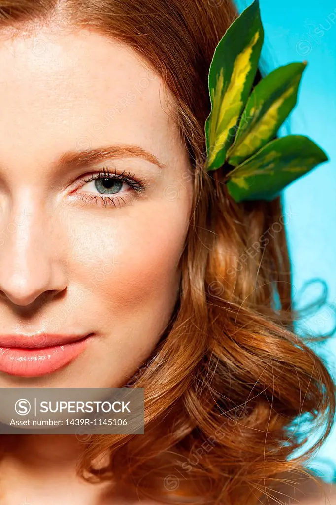 Woman with leaves in hair