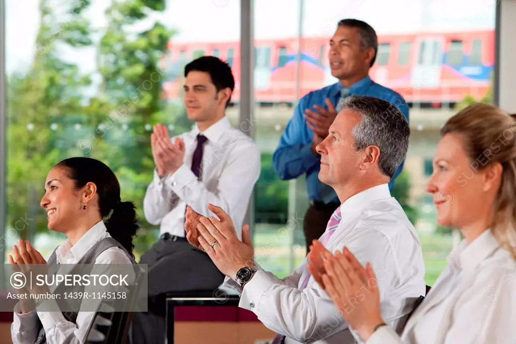 Businesspeople clapping at meeting