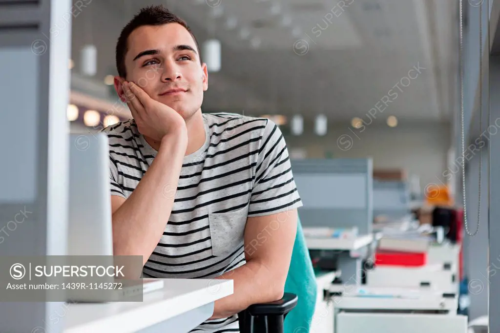 Man daydreaming at desk