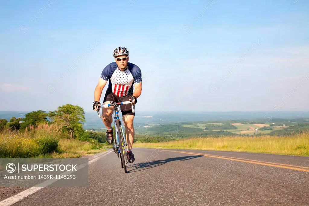 Man cycling on open road