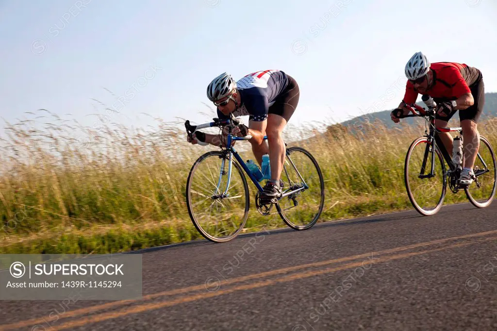 Two cyclists or road, racing downhill