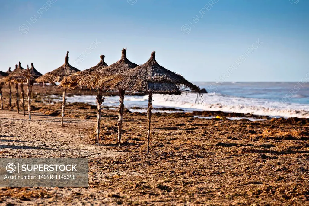 Parasols on beach on island of Djerba, Tunisia