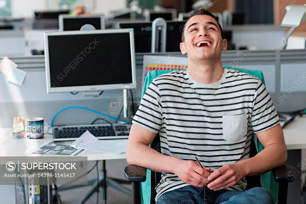 Man laughing in office