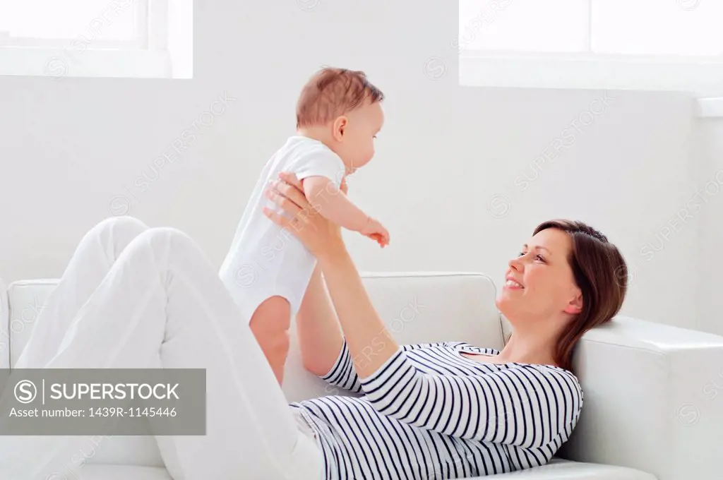 Woman on sofa with baby daughter