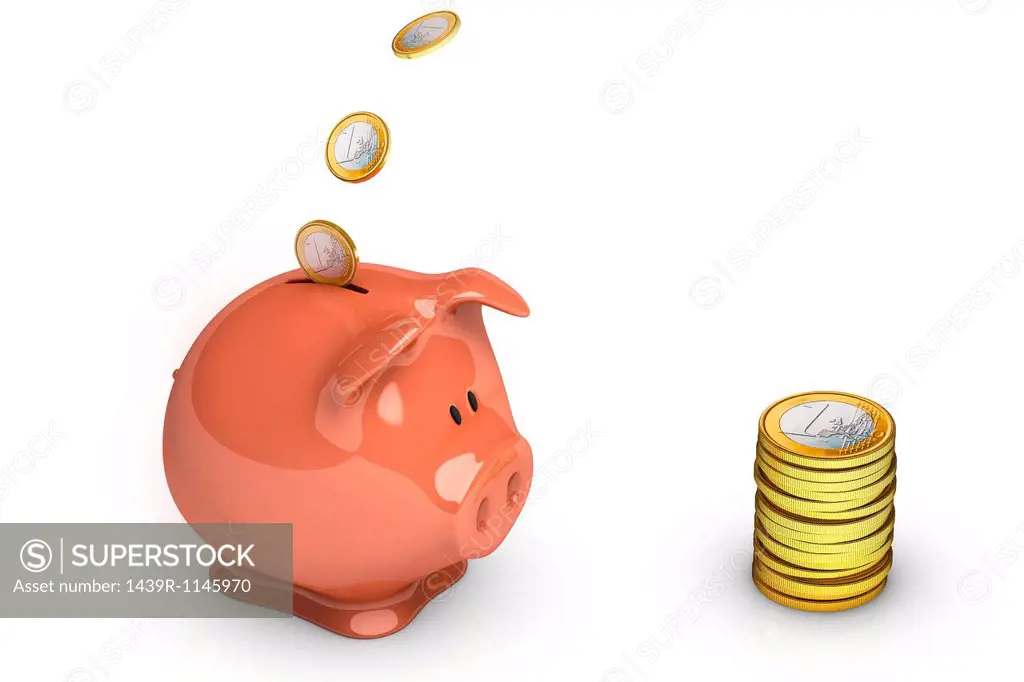 Euro coins going into piggy bank