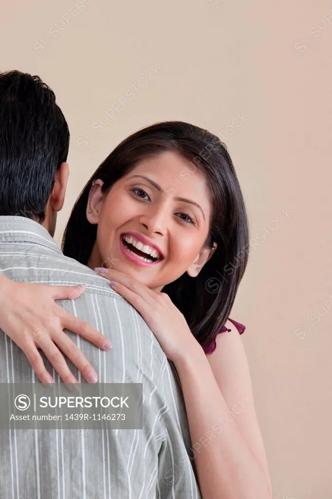 Portrait of woman hugging her husband