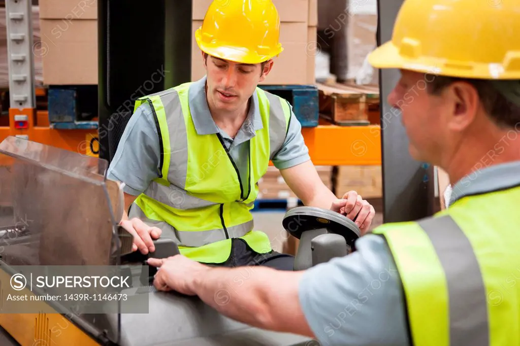Men with machinery in warehouse