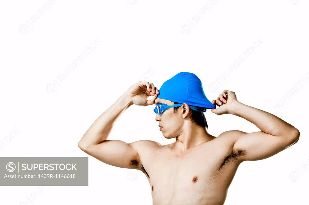 Swimmer putting on swimming cap