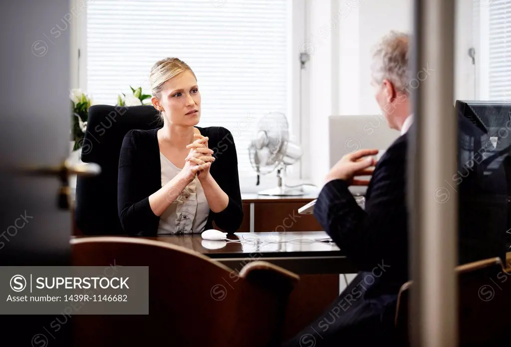 Colleagues talking in office