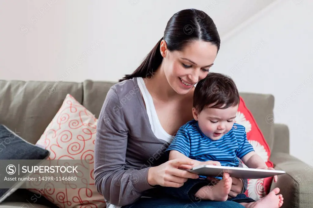 Mother and baby looking at digital tablet